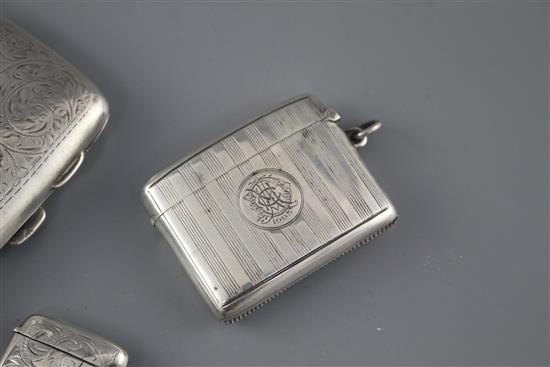 An Edwardian engraved silver cigarette case, Samuel M. Levi, Birmingham, 1905 and two similar vesta cases,
